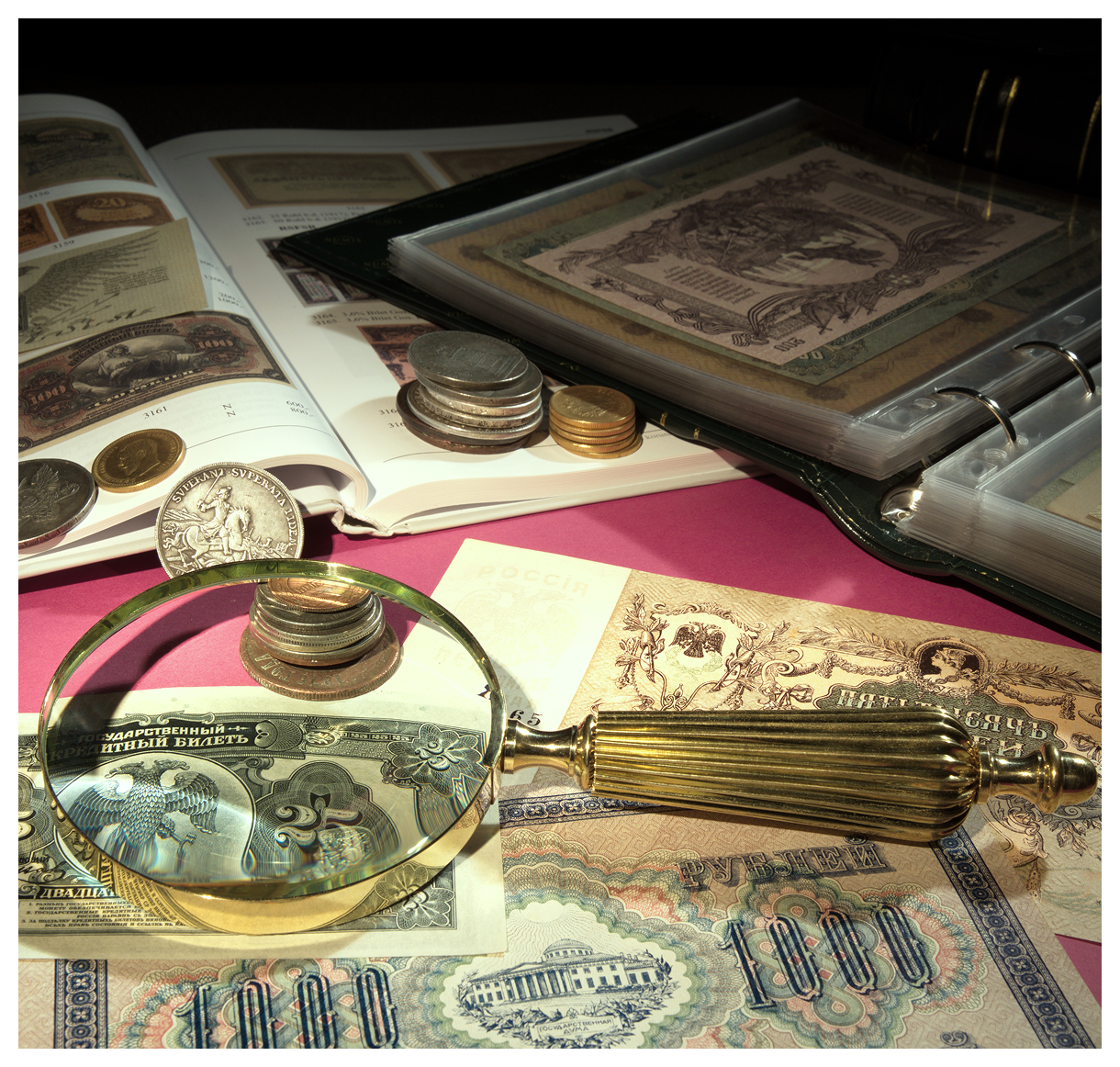 Magnifying glass, coins, and vintage currency collection.