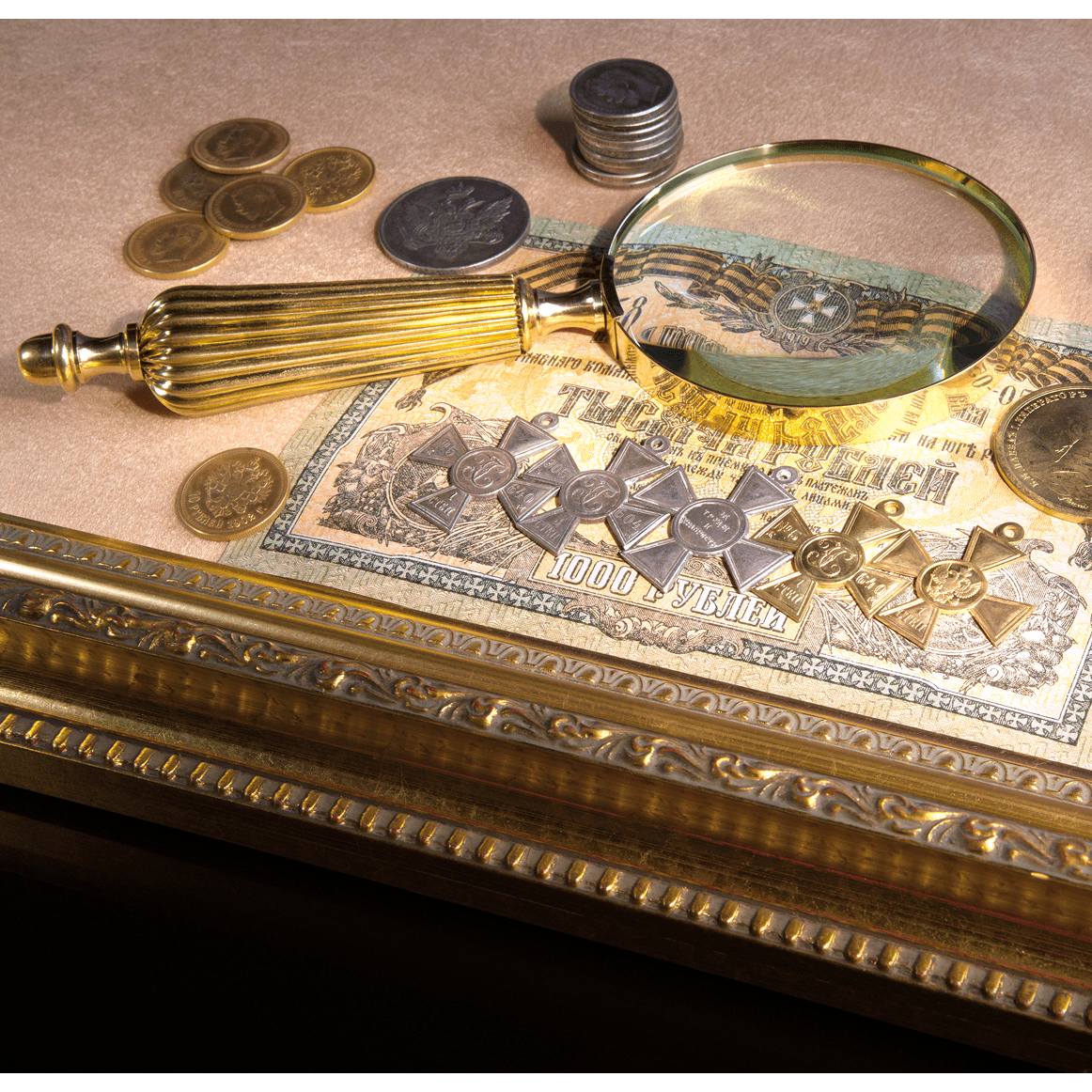 Magnifying glass, coins, and antique document on table.